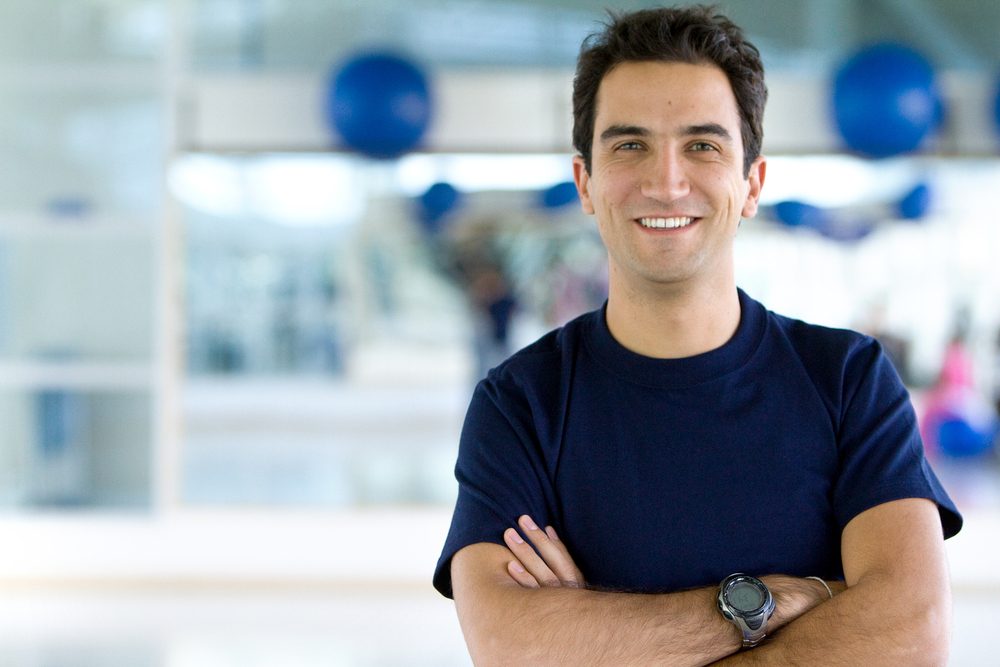 Handsome male portait at the gym smiling