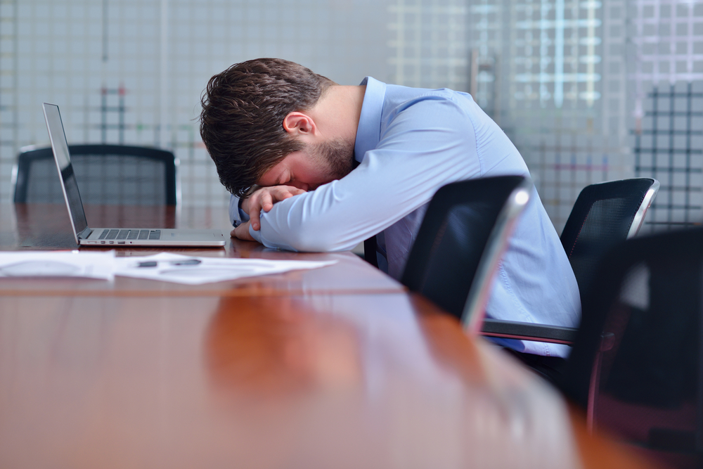 Young business man with problems and stress in the office